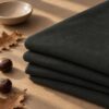 Asphalt merino wool jersey folded in autumn light