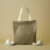 Tote bag in olive canvas fabric with light handles (AI-generated illustration)