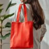 Mulepose syet i canvas stof orange (AI-genereret illustration)