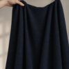 Midnight Blue merino wool jersey, held in the hand