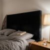 Headboard upholstered in black upholstery velour (AI-generated illustration)