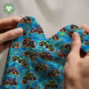 Monster trucks on blue, digital print jersey draped to show the fabric’s drape and softness