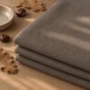Mushroom merino wool jersey, folded in autumn light