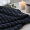 Navy Blue Mosaic merino wool jersey, folded by candlelight
