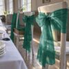Chair bow made from bottle green organza for a wedding