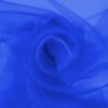 Cobalt blue organza arranged in soft folds, lightweight sheer fabric