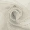 Light greige organza arranged in soft folds, lightweight transparent fabric