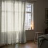 Light greige organza curtain in front of a window