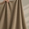 Sand merino wool jersey, held up in the hand