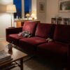 Sofa upholstered in dark red velour (AI-generated illustration)