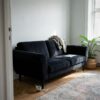 Sofa upholstered in black velour (AI-generated illustration)